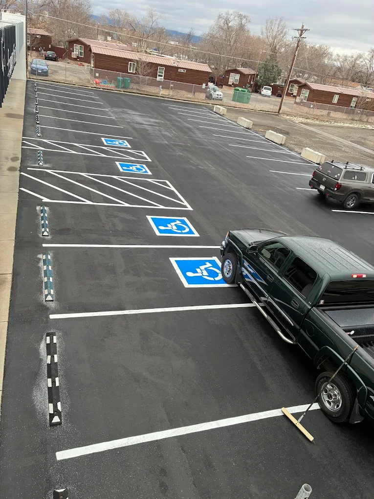 Striped accessible parking spaces in a fresh asphalt lot