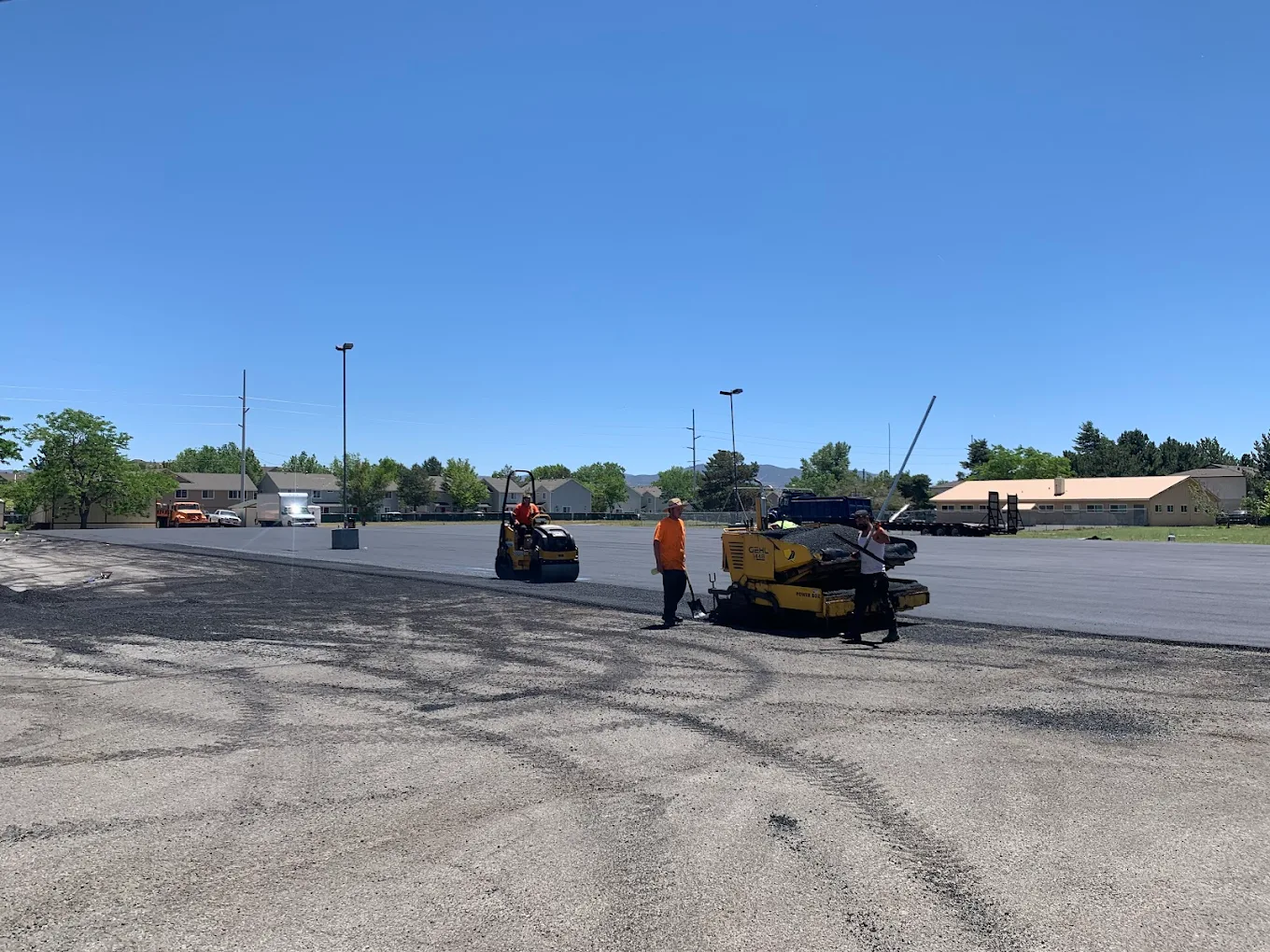 D&M Paving laying hot mix asphalt on a commercial lot