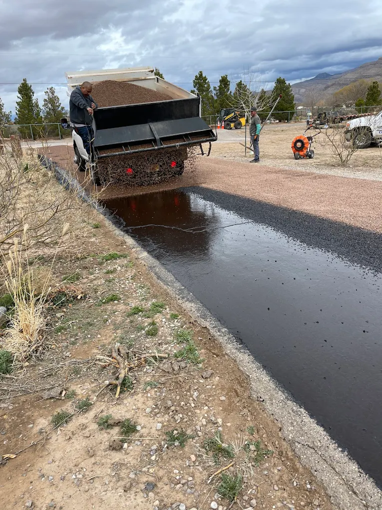 Chip seal aggregate being applied to a fresh oiled road