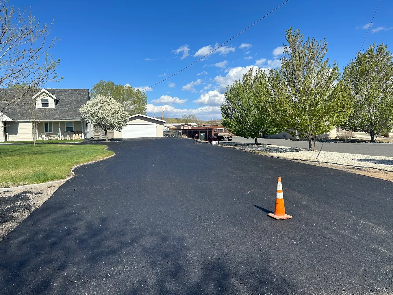 Freshly paved residential asphalt driveway by D&M Paving